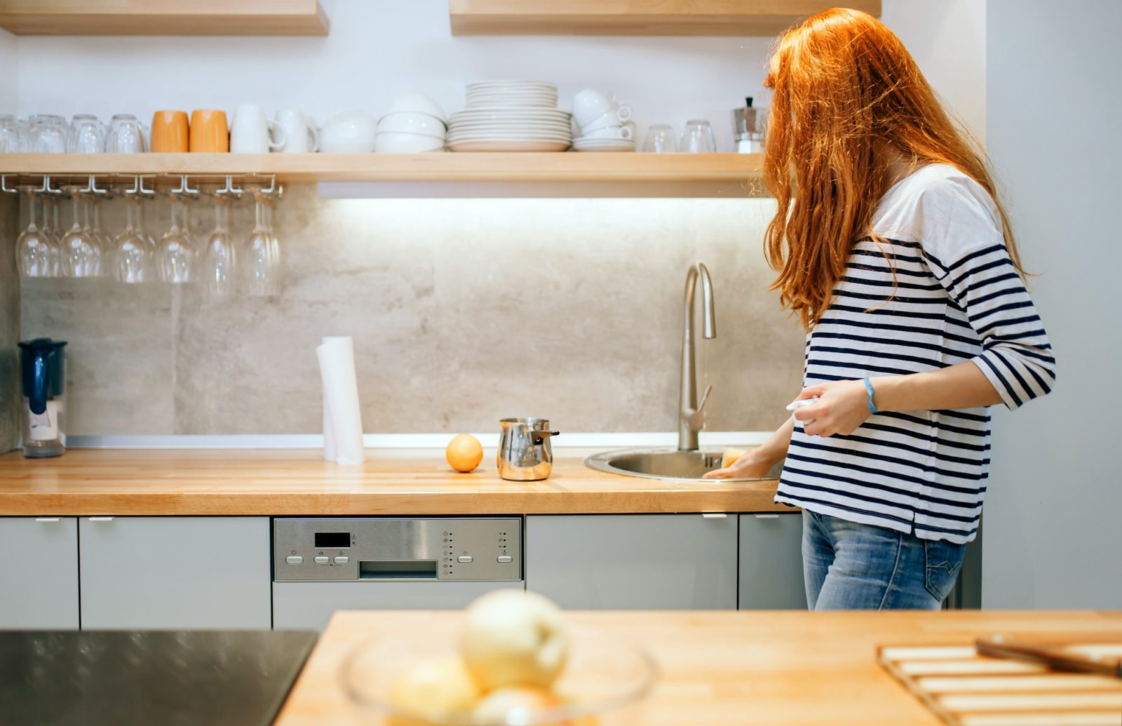 Woman keeping kitchen tidy and clean